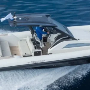 Top-down view of a luxurious speedboat cruising through the clear blue waters of the Athens Riviera coastline