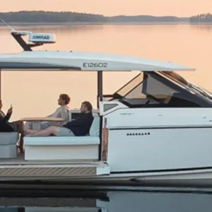 Saxdor 400 GTO in Paros. A luxury motor yacht cruising on calm water at sunset with guests relaxing onboard