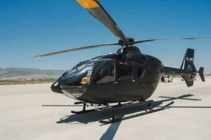 Airbus H135 P2 helicopter departing from Athens Airport for a luxury private helicopter transfer in Greece.