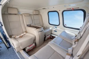 Luxury interior cabin of an Agusta A109S Grand helicopter for VIP transfers departing from Athens Airport.