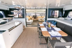 Lower deck interior of a Lagoon 620 luxury catamaran featuring spacious cabins, soft ambient lighting, and modern yacht finishes.